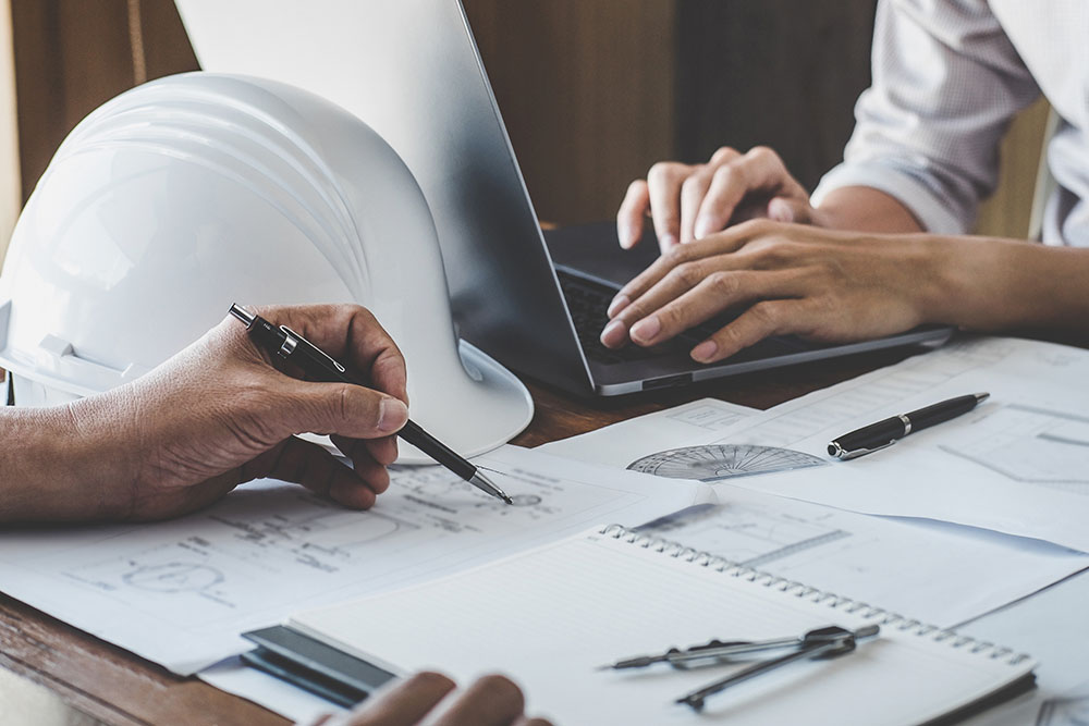 Engineer working drawing on blueprint