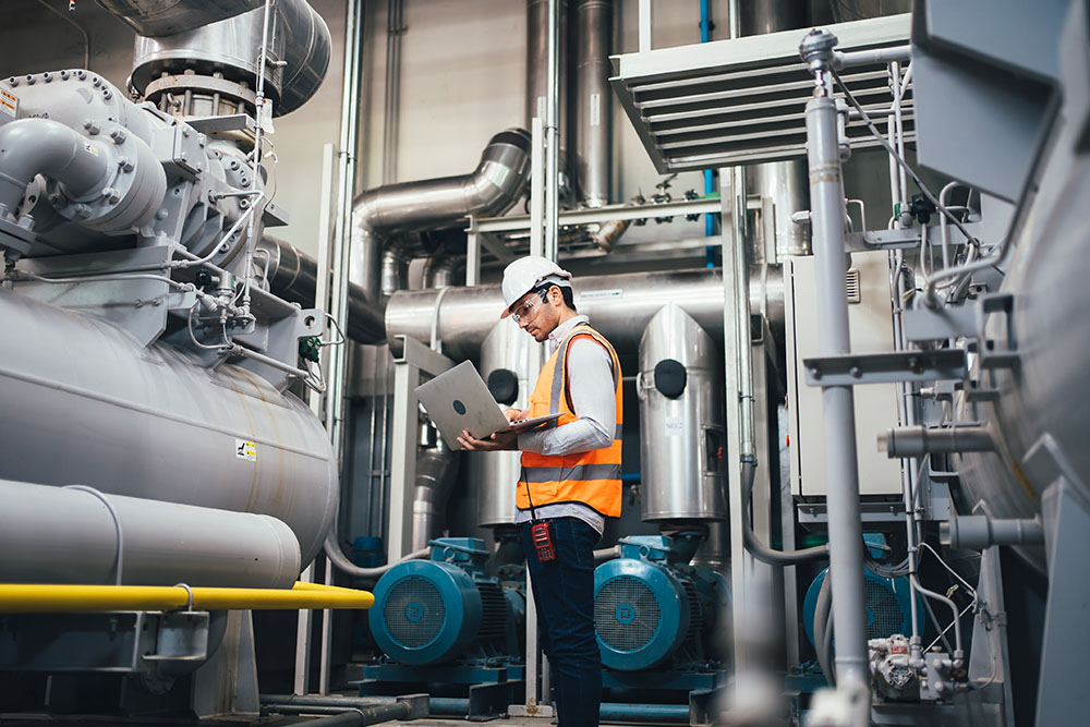 Professional worker of modern factory using laptop